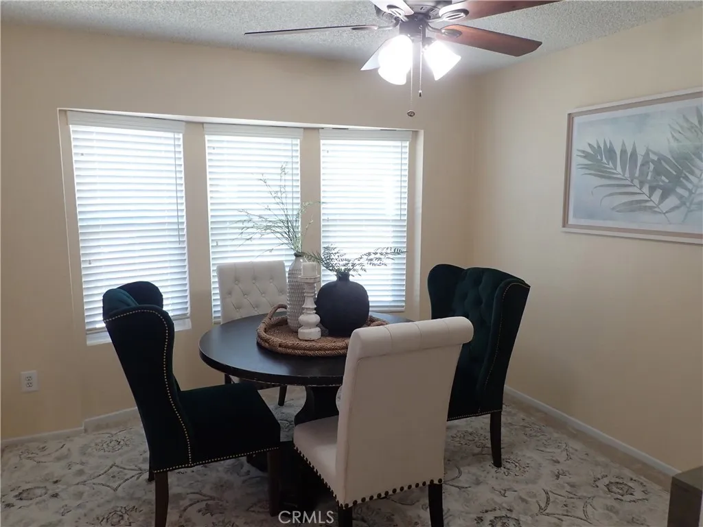 27250 Murrieta Road, Unit 75 Menifee, CA 92586 - Photo 5 of 29 a view of a dining room with furniture window and wooden floor