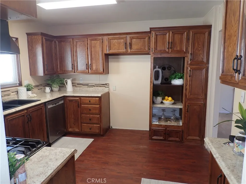 27250 Murrieta Road, Unit 75 Menifee, CA 92586 - Photo 6 of 29 a kitchen with a refrigerator and a stove top oven