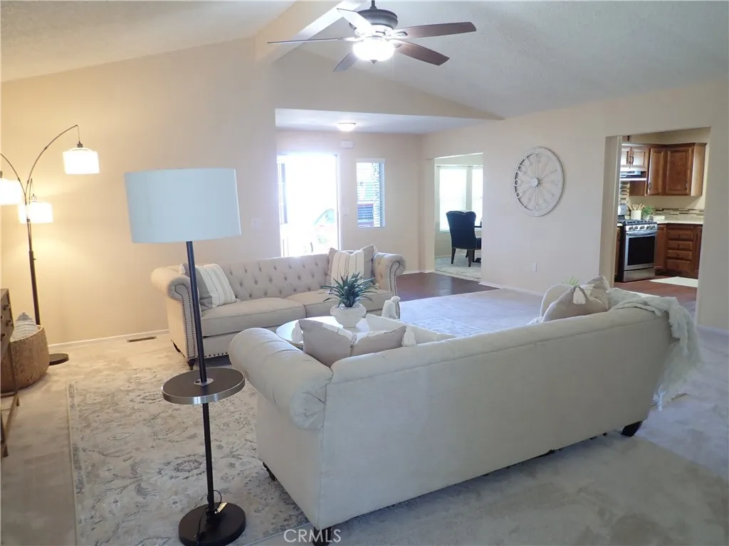 27250 Murrieta Road, Unit 75 Menifee, CA 92586 - Photo 10 of 29 a living room with furniture a lamp and a window