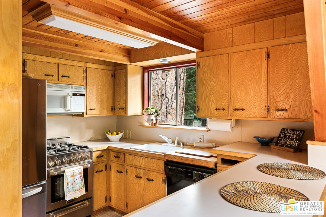 24601 Fern Valley Road Idyllwild, CA 92549 - Photo 15 of 50 a kitchen with a sink stove and cabinets