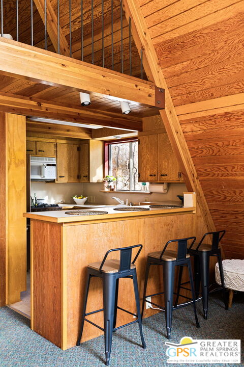 24601 Fern Valley Road Idyllwild, CA 92549 - Photo 16 of 50 a dining table with chairs and wooden floor