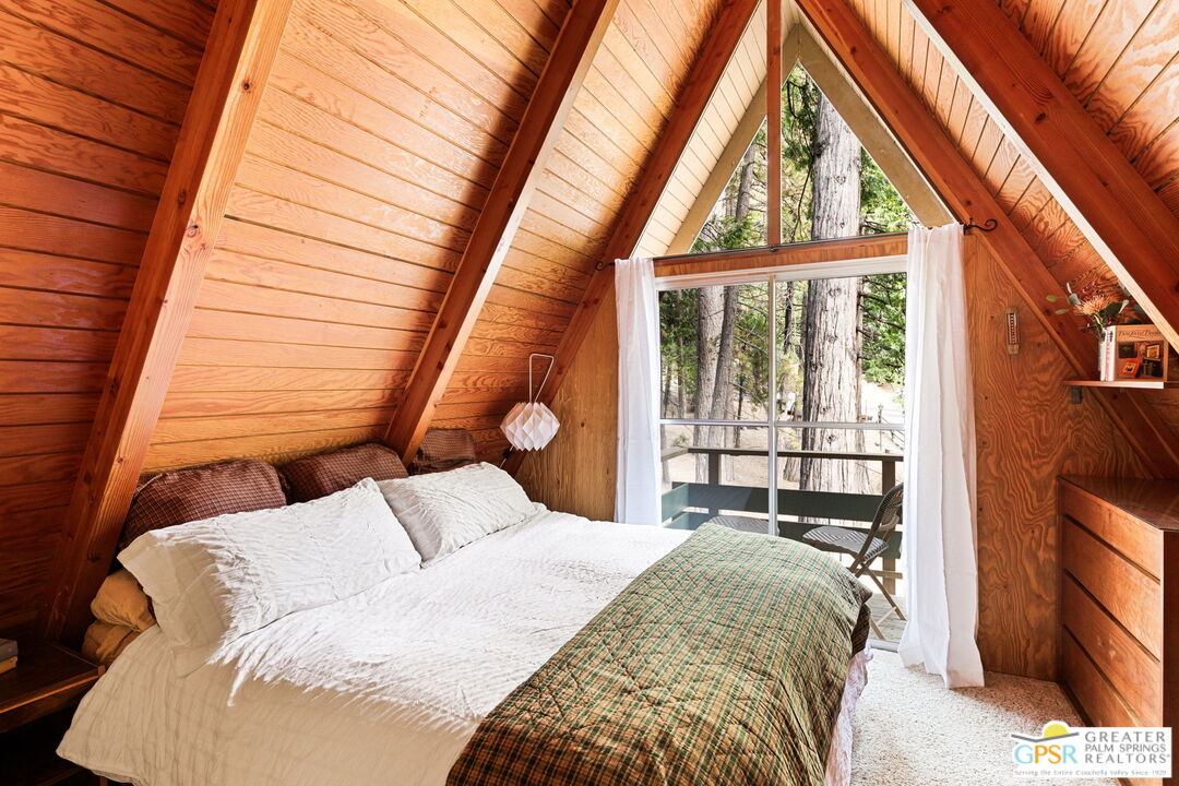 24601 Fern Valley Road Idyllwild, CA 92549 - Photo 21 of 50 a bedroom with a bed and a large window