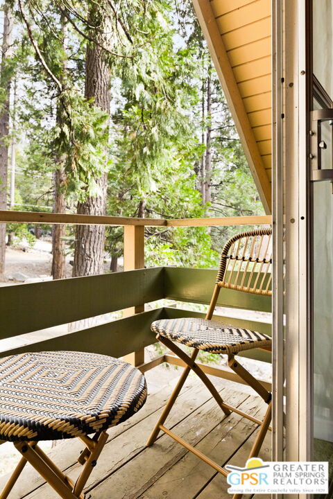 24601 Fern Valley Road Idyllwild, CA 92549 - Photo 26 of 50 a view of a balcony with chairs and wooden floor