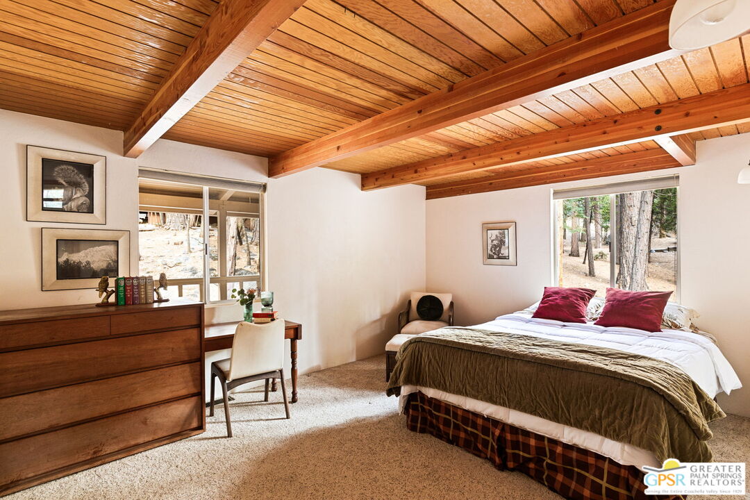 24601 Fern Valley Road Idyllwild, CA 92549 - Photo 30 of 50 a bedroom with a bed a balcony view and a couch