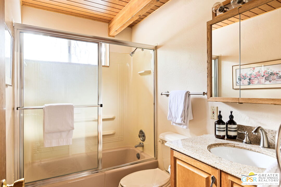 24601 Fern Valley Road Idyllwild, CA 92549 - Photo 32 of 50 a bathroom with a granite countertop sink toilet and shower