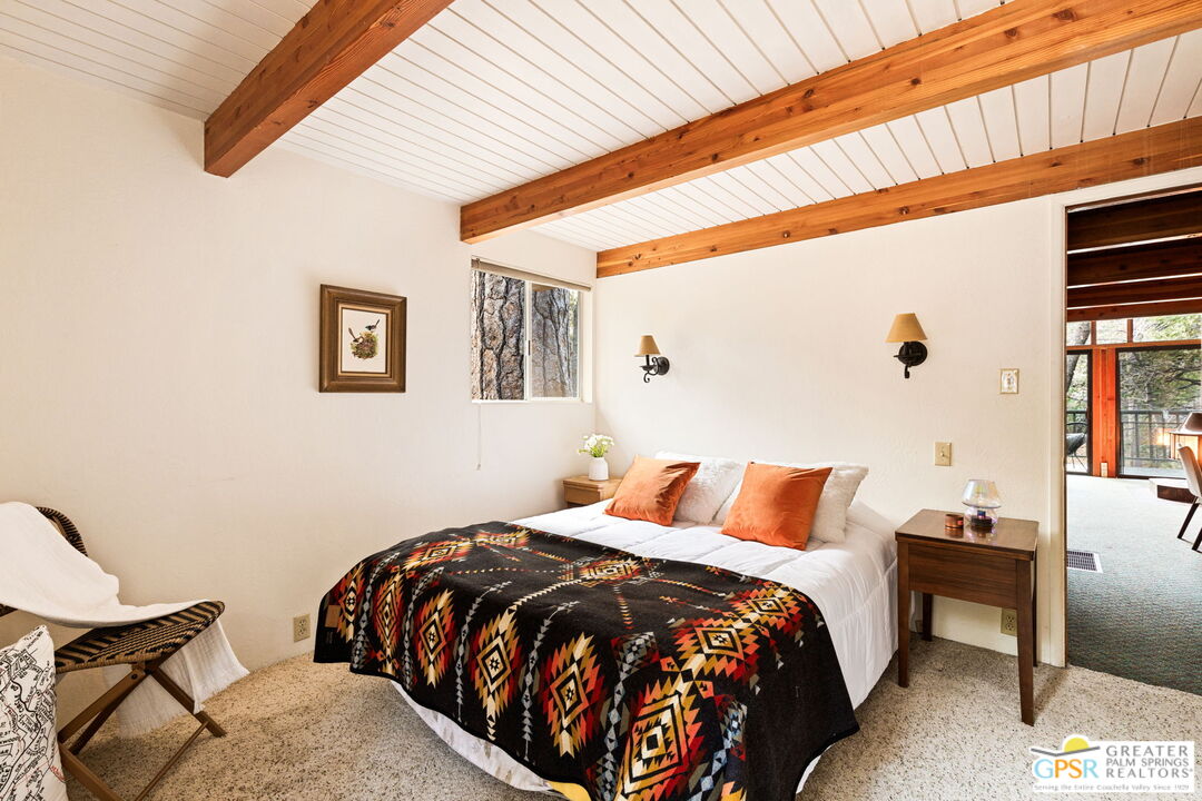 24601 Fern Valley Road Idyllwild, CA 92549 - Photo 35 of 50 a bedroom with a bed and wooden floor