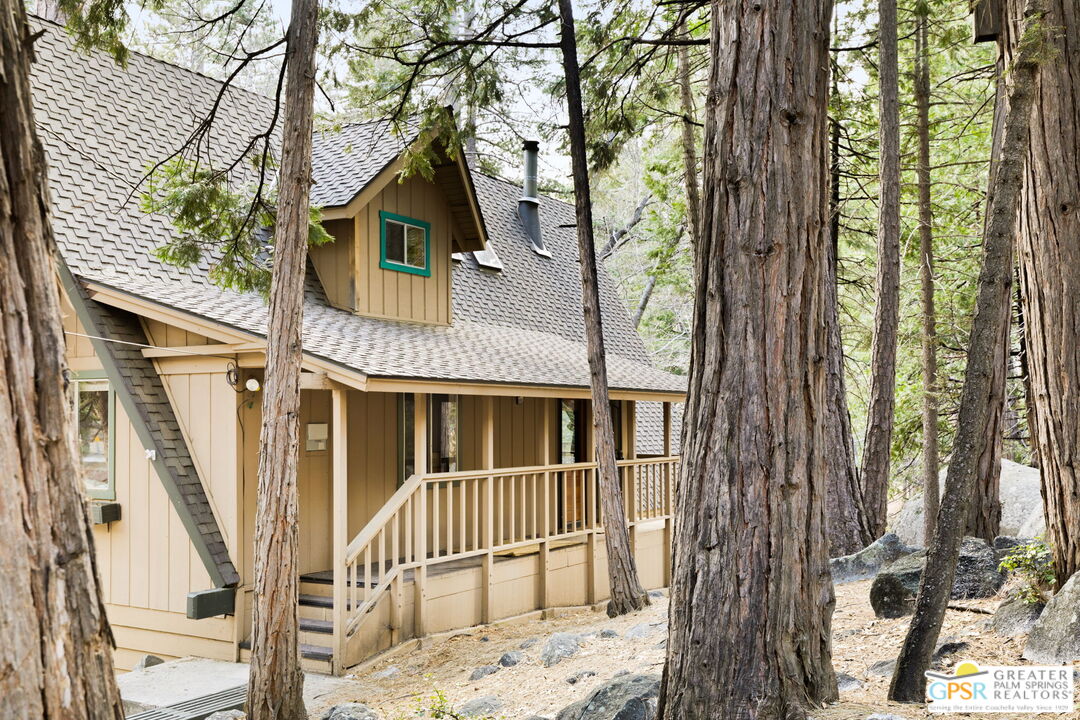 24601 Fern Valley Road Idyllwild, CA 92549 - Photo 4 of 50 a view of a brick house with large trees