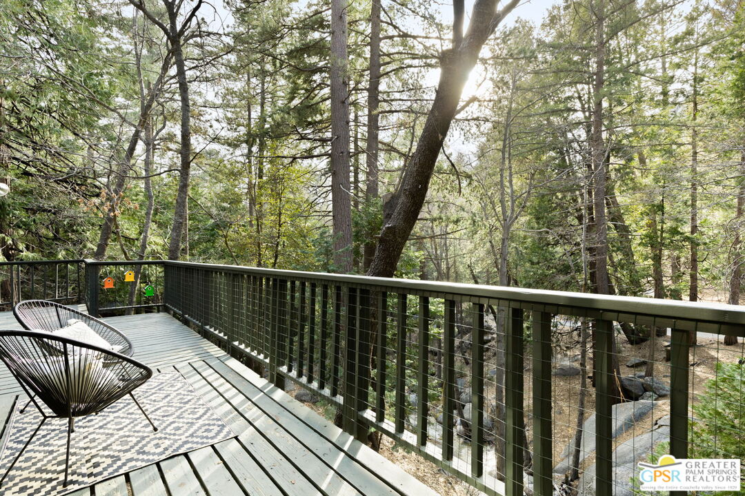24601 Fern Valley Road Idyllwild, CA 92549 - Photo 41 of 50 a view of balcony with wooden floor and outdoor seating