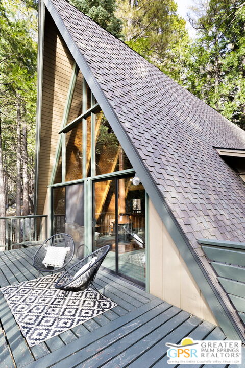 24601 Fern Valley Road Idyllwild, CA 92549 - Photo 43 of 50 a view of a balcony with wooden floor and fence and a potted plant