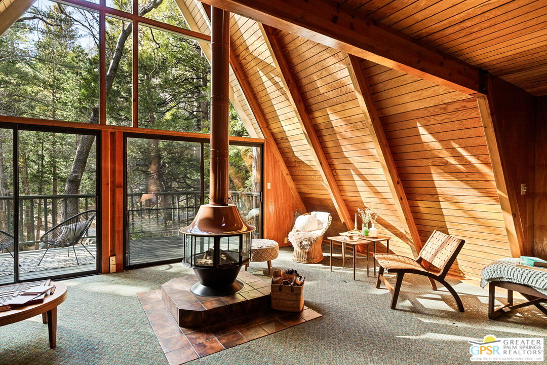24601 Fern Valley Road Idyllwild, CA 92549 - Photo 7 of 50 a living room with furniture and floor to ceiling windows