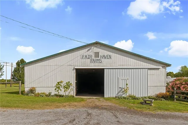 a view of a house with swimming pool and a yard