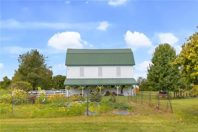 a view of a lake with a bench and trees around