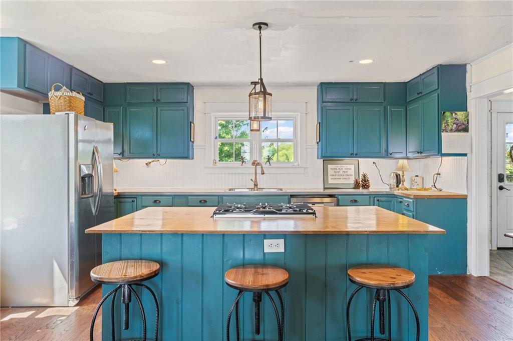 206 Lee Road Grove City, PA 16127 - Photo 42 of 45 a kitchen with stainless steel appliances granite countertop a dining table chairs and sink
