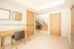 a view of a living room with a table and chair