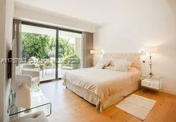 a bedroom with a bed and glass window