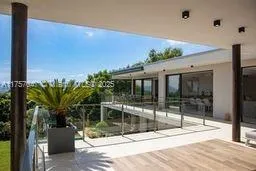 a view of potted plants in front of a house