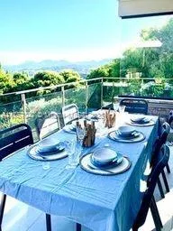 a view of a lake with couches table and chairs