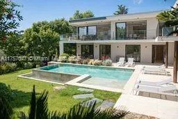 a view of a house with swimming pool and a yard