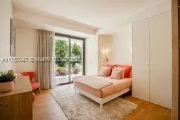 a bedroom with a bed and glass door