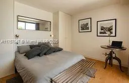 a bedroom with a bed and a table