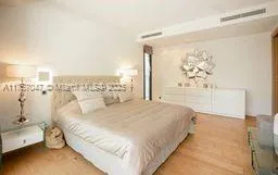 a spacious bedroom with a bed and a window