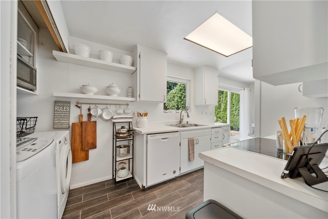 2915 193rd Place Southeast Bothell, WA 98012 - Photo 7 of 17 a kitchen with stainless steel appliances a stove a sink and a refrigerator