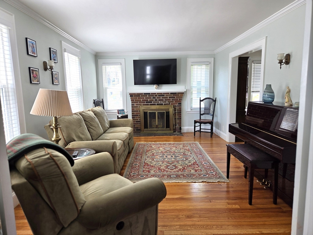 25 Waldeck Road Milton, MA 02186 - Photo 3 of 34 a living room with furniture fireplace and flat screen tv
