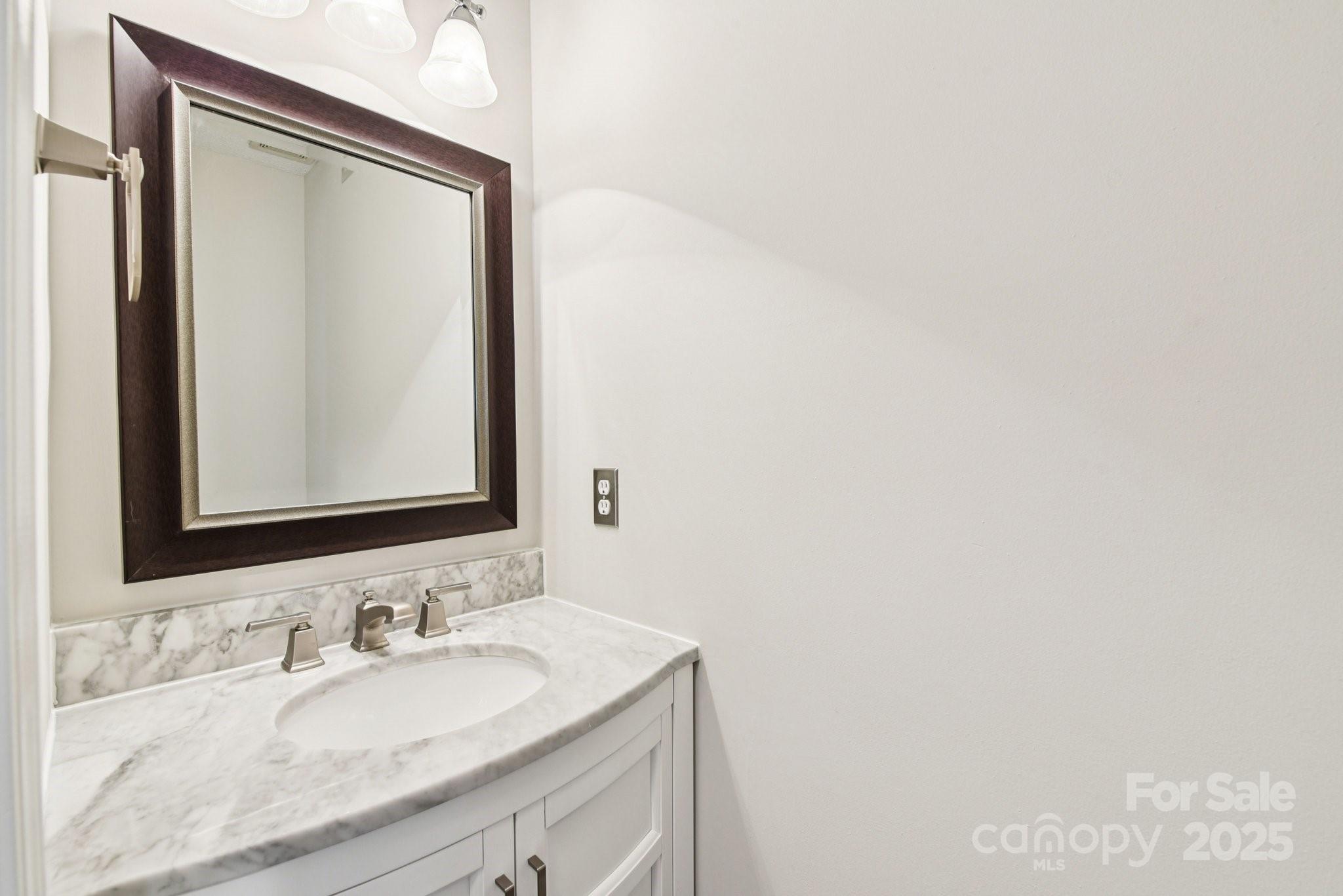 8700 Barrister Way Charlotte, NC 28216 - Photo 12 of 25 a bathroom with a granite countertop sink and a mirror