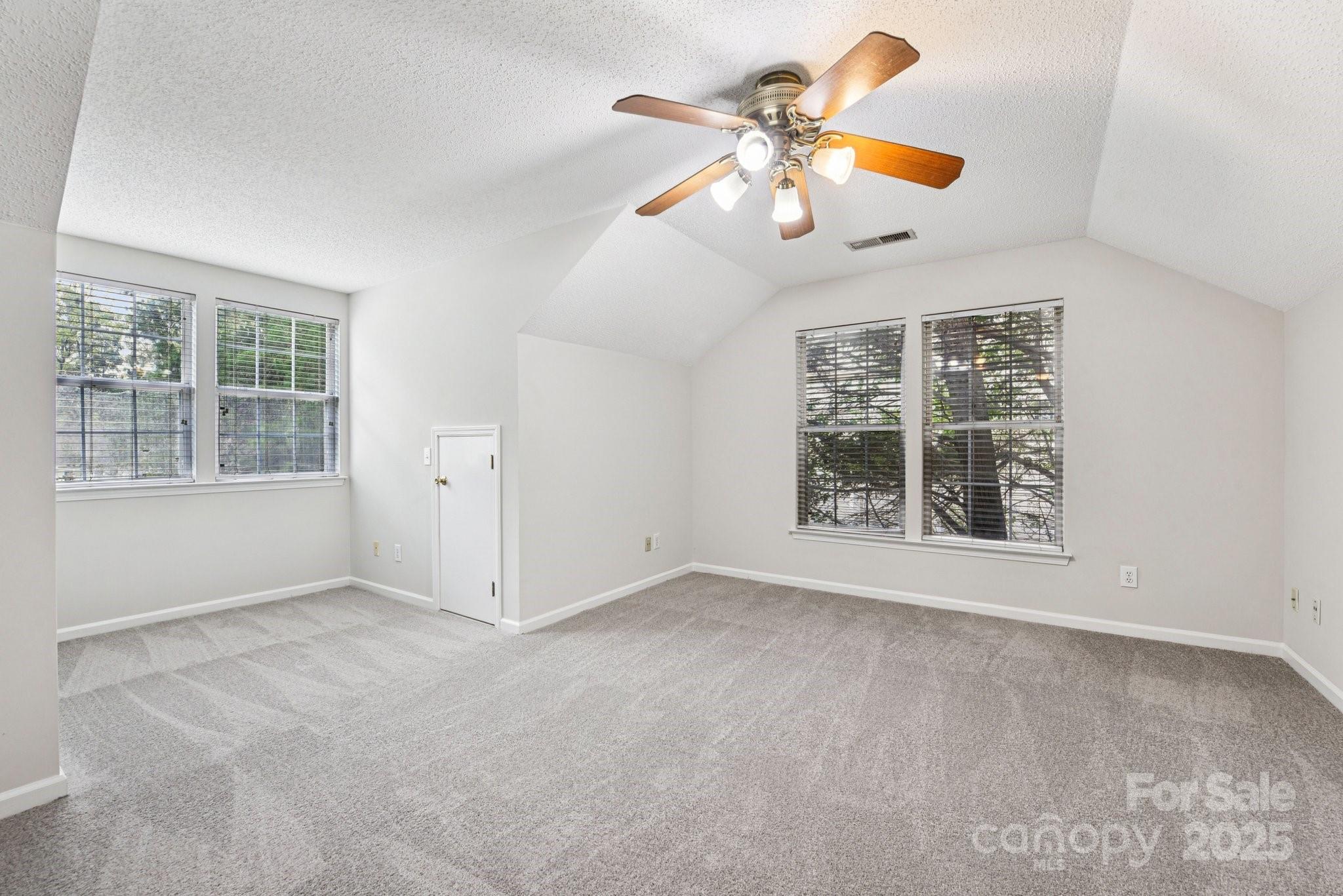 8700 Barrister Way Charlotte, NC 28216 - Photo 15 of 25 an empty room with windows and ceiling fan