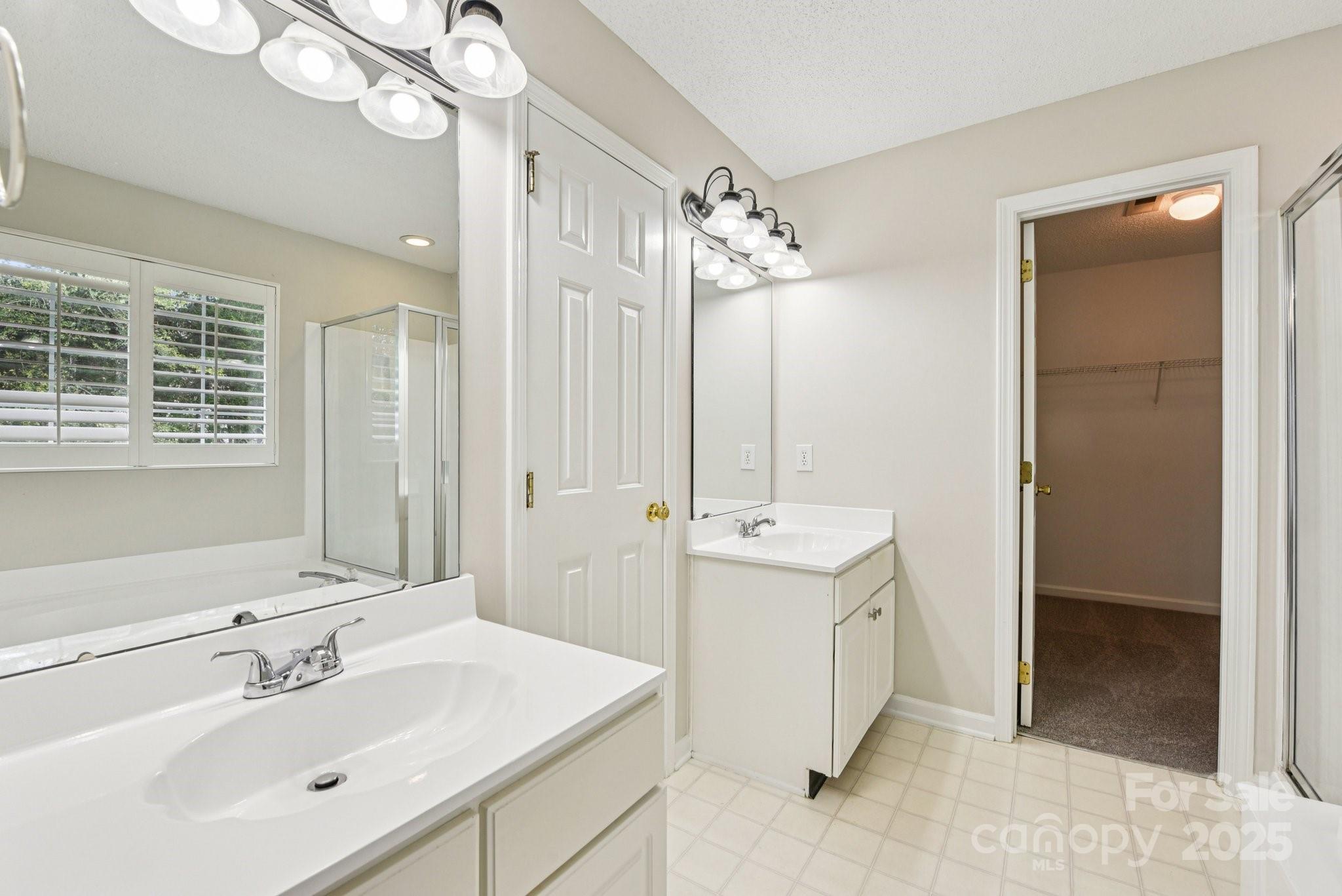 8700 Barrister Way Charlotte, NC 28216 - Photo 20 of 25 a spacious bathroom with a double vanity sink mirror and