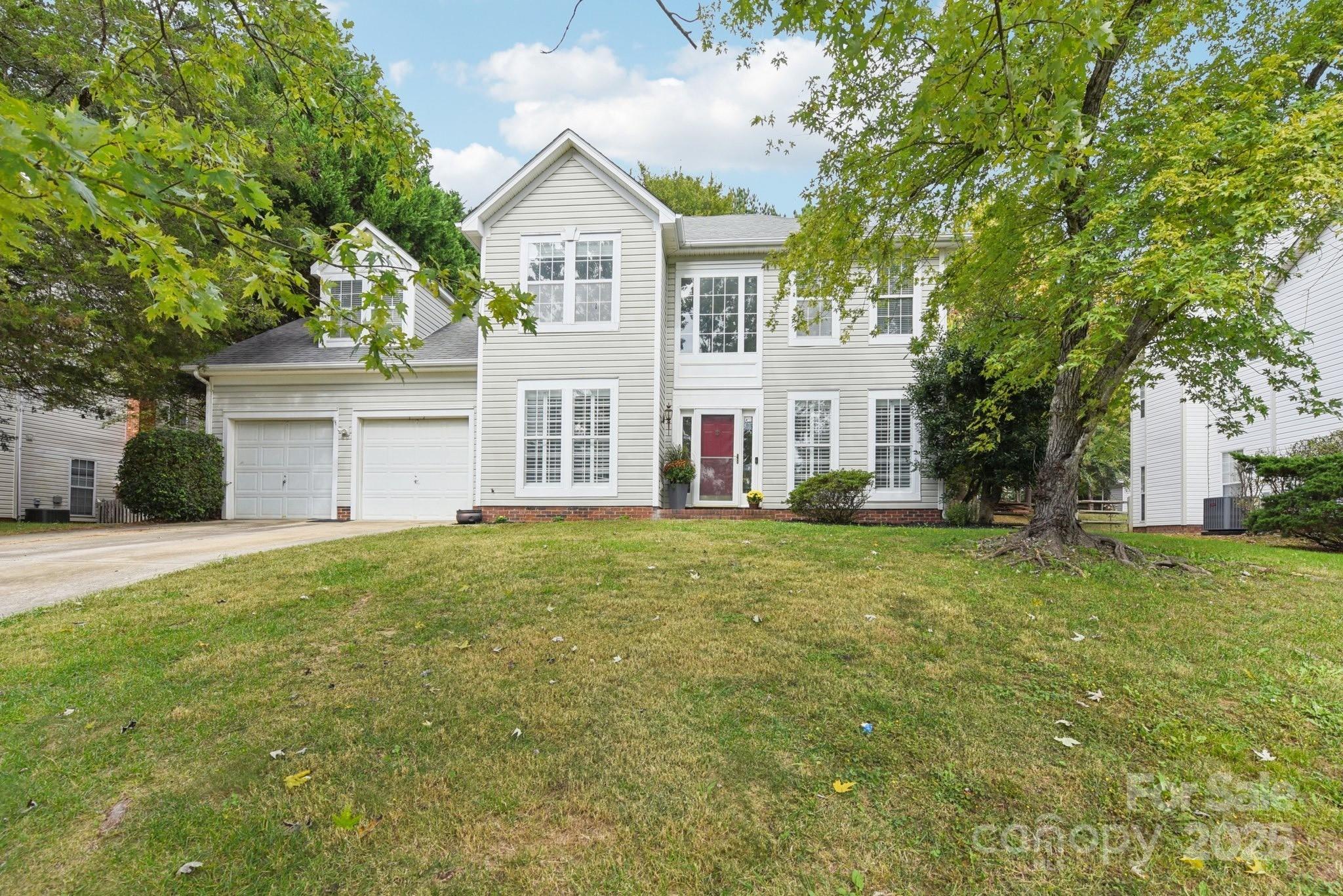 8700 Barrister Way Charlotte, NC 28216 - Photo 2 of 25 a front view of a house with a yard and garage