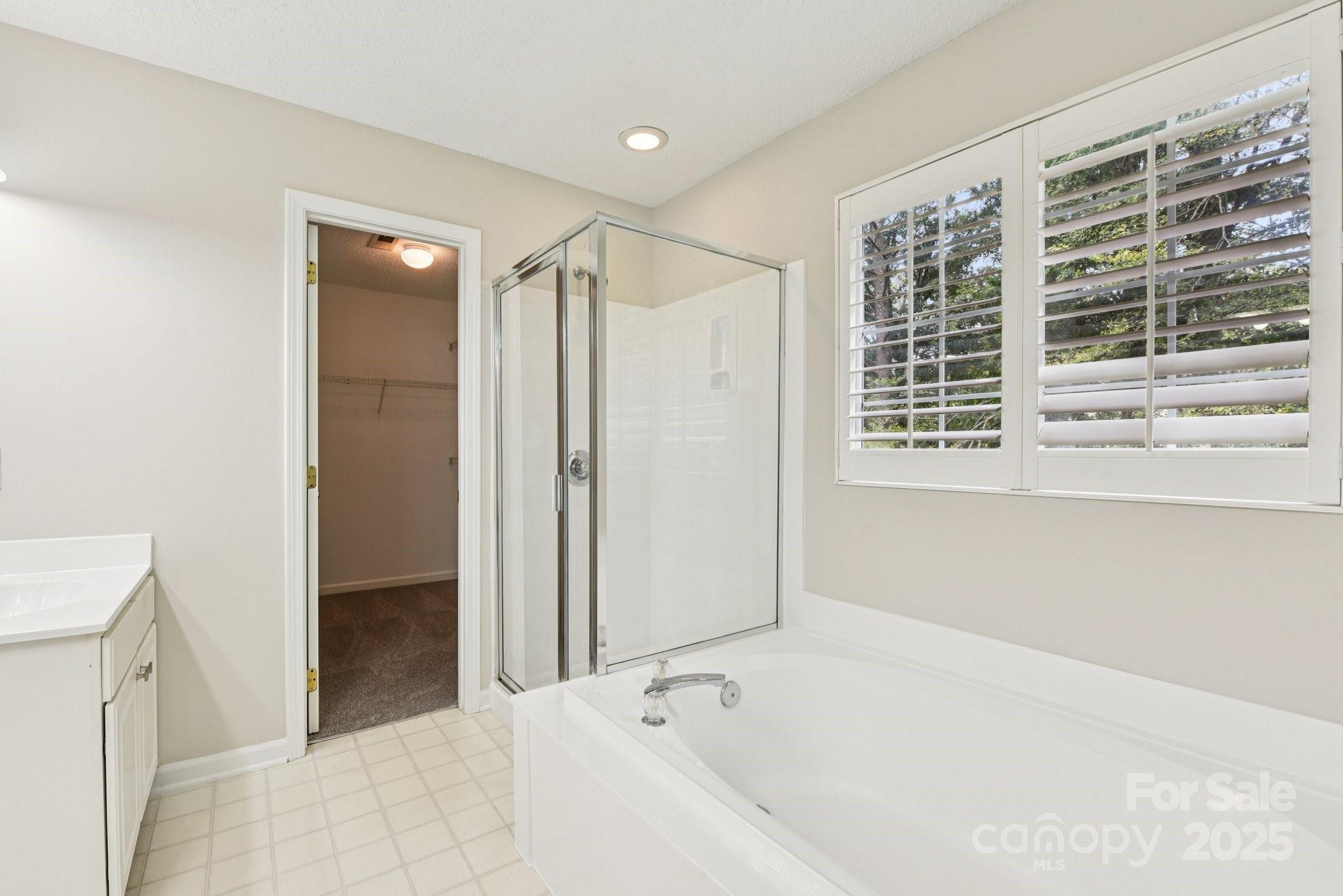 8700 Barrister Way Charlotte, NC 28216 - Photo 21 of 25 a bathroom with a bathtub and a shower