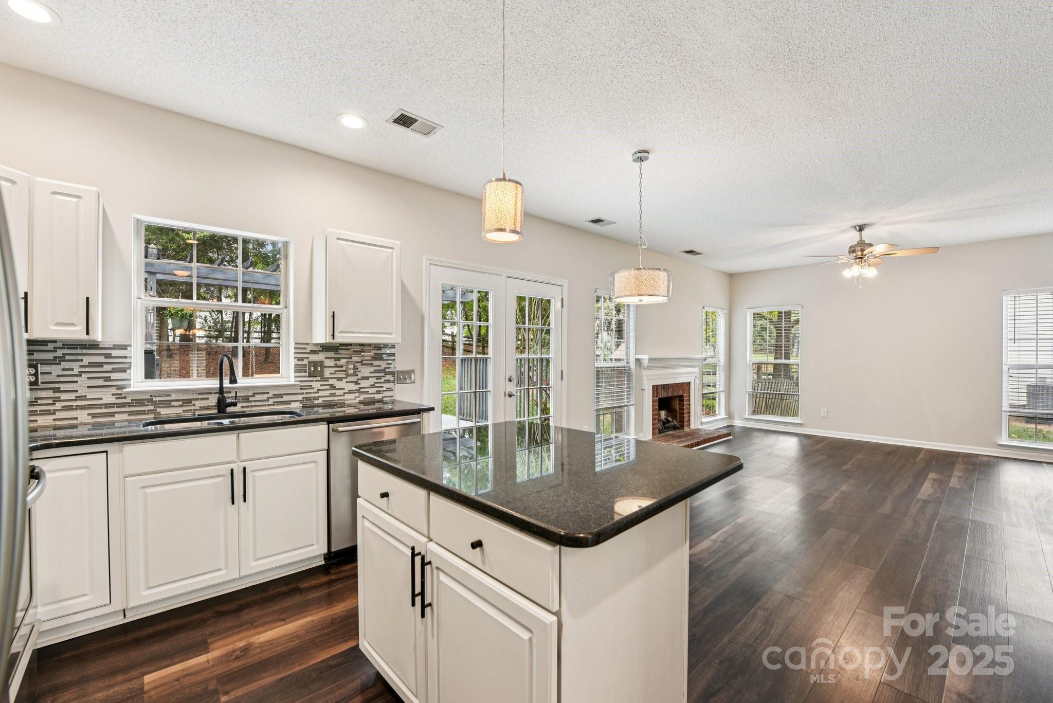 8700 Barrister Way Charlotte, NC 28216 - Photo 6 of 25 a kitchen with granite countertop a sink cabinets and wooden floor
