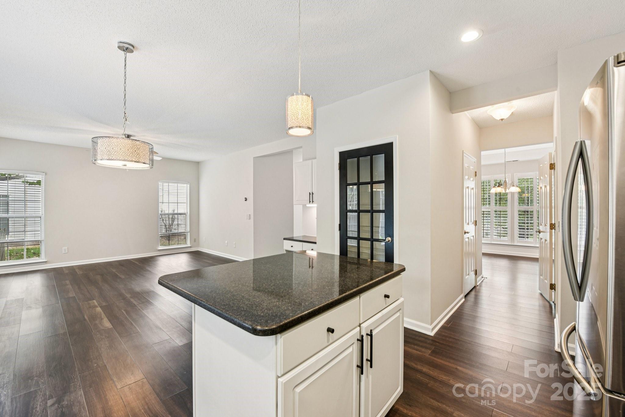 8700 Barrister Way Charlotte, NC 28216 - Photo 8 of 25 a kitchen with granite countertop a stove and a wooden floor