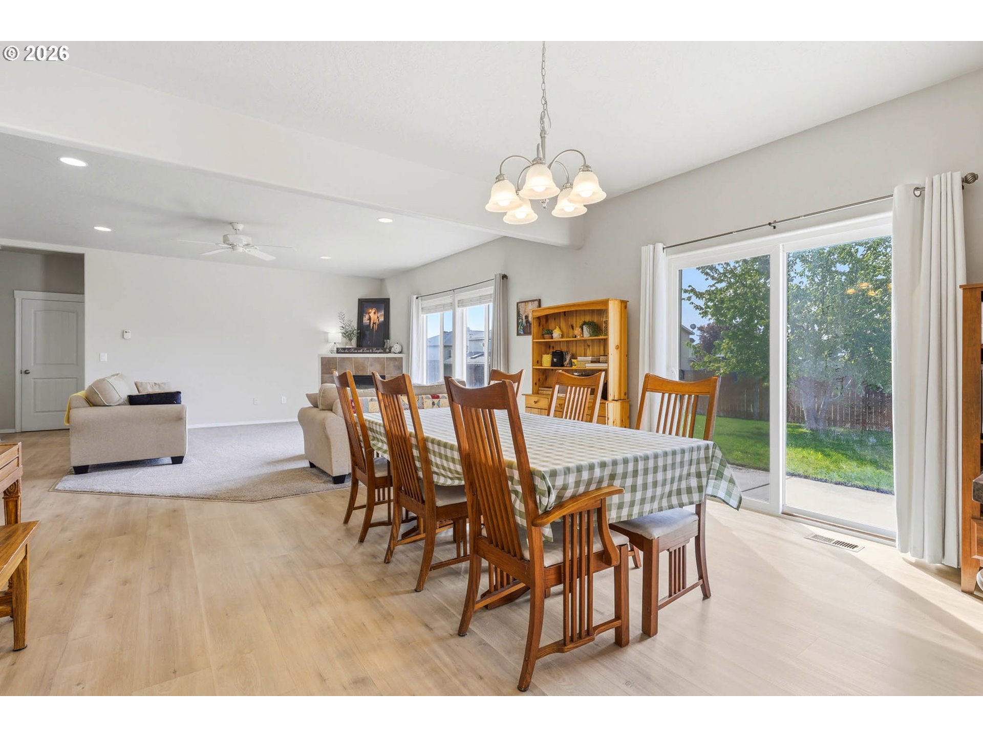 213 Sandy Court Boardman, OR 97818 - Photo 12 of 39 a view of a dining room and livingroom with furniture wooden floor a chandelier