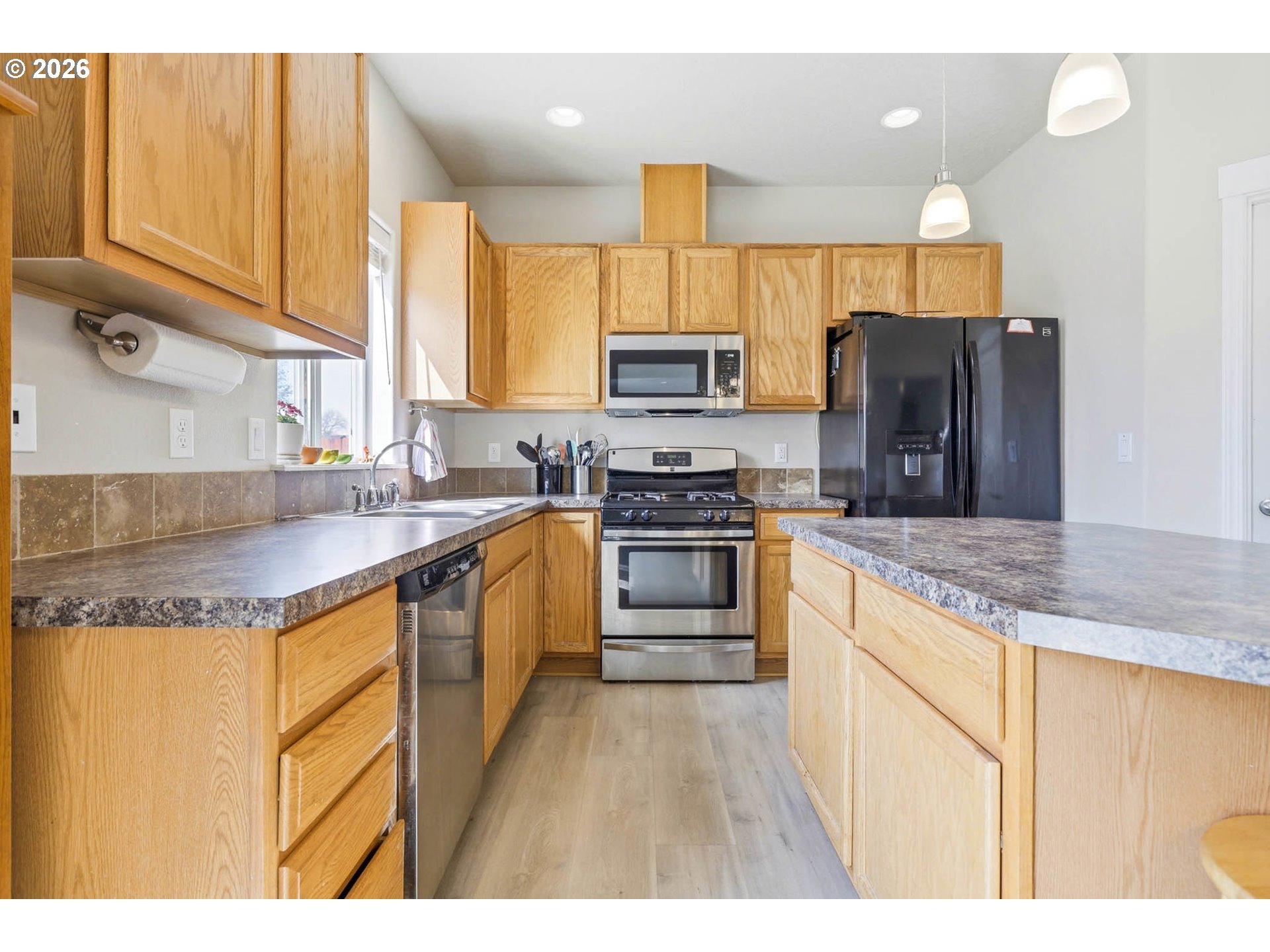 213 Sandy Court Boardman, OR 97818 - Photo 14 of 39 a kitchen with stainless steel appliances granite countertop a sink stove and refrigerator