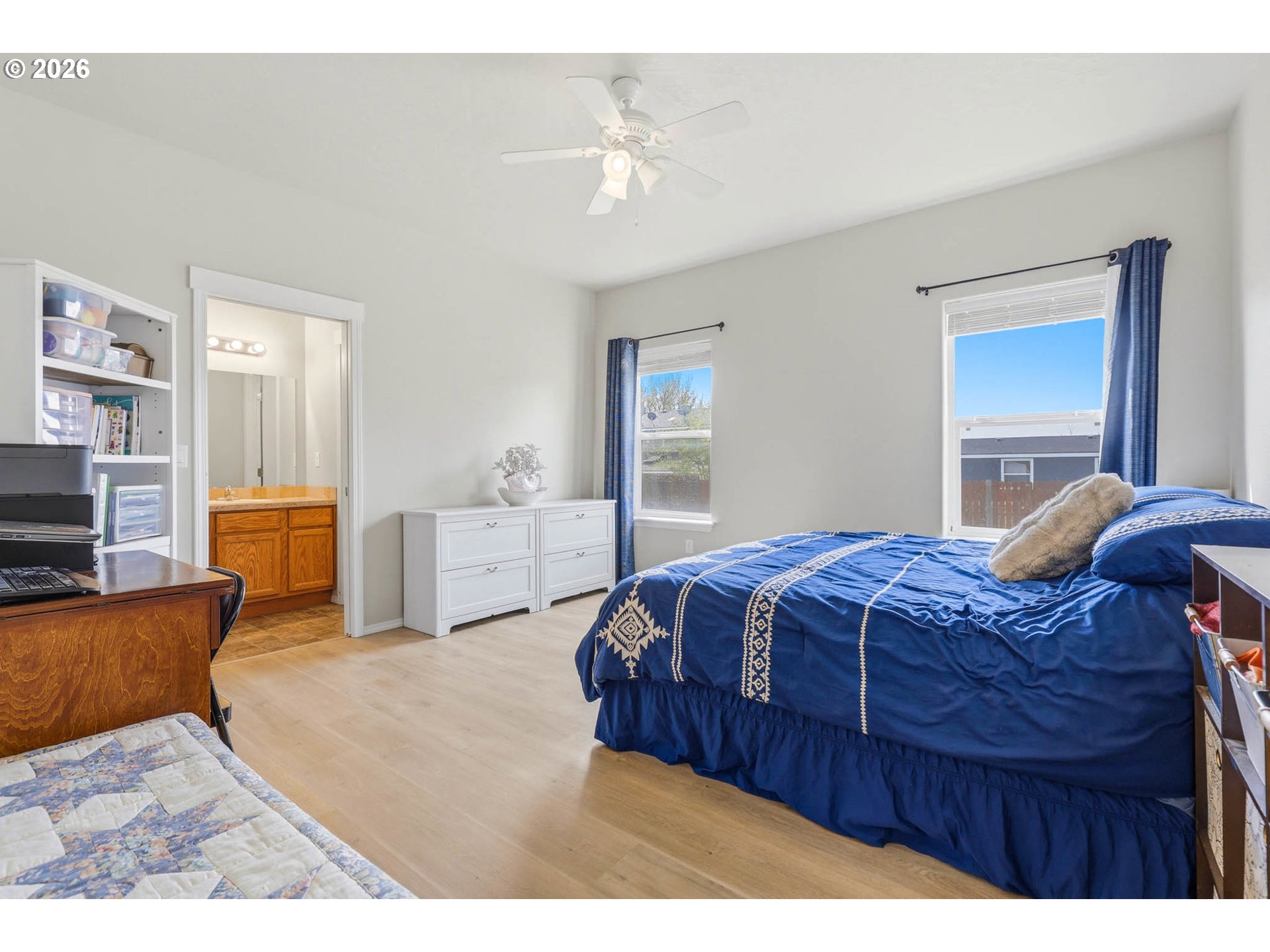 213 Sandy Court Boardman, OR 97818 - Photo 18 of 39 a bedroom with a large bed and a chandelier