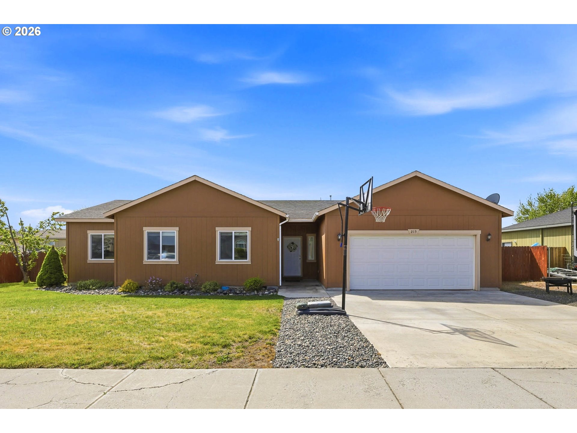 213 Sandy Court Boardman, OR 97818 - Photo 2 of 39 a front view of a house with a yard and garage
