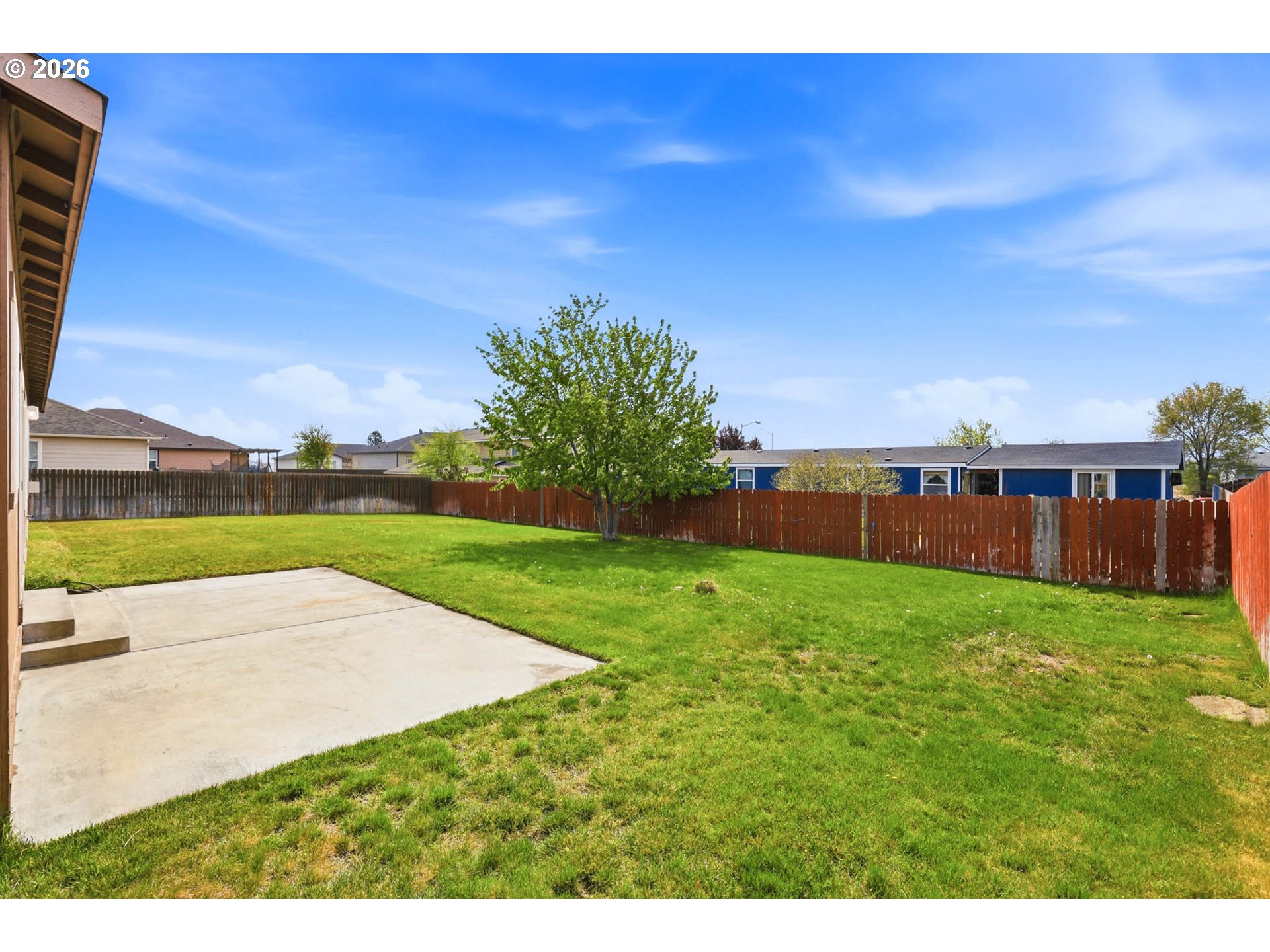 213 Sandy Court Boardman, OR 97818 - Photo 27 of 39 a view of a garden with a building in the background