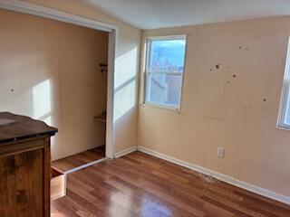 4100 Howard Street Hobart, IN 46342 - Photo 12 of 36 an empty room with wooden floor and windows