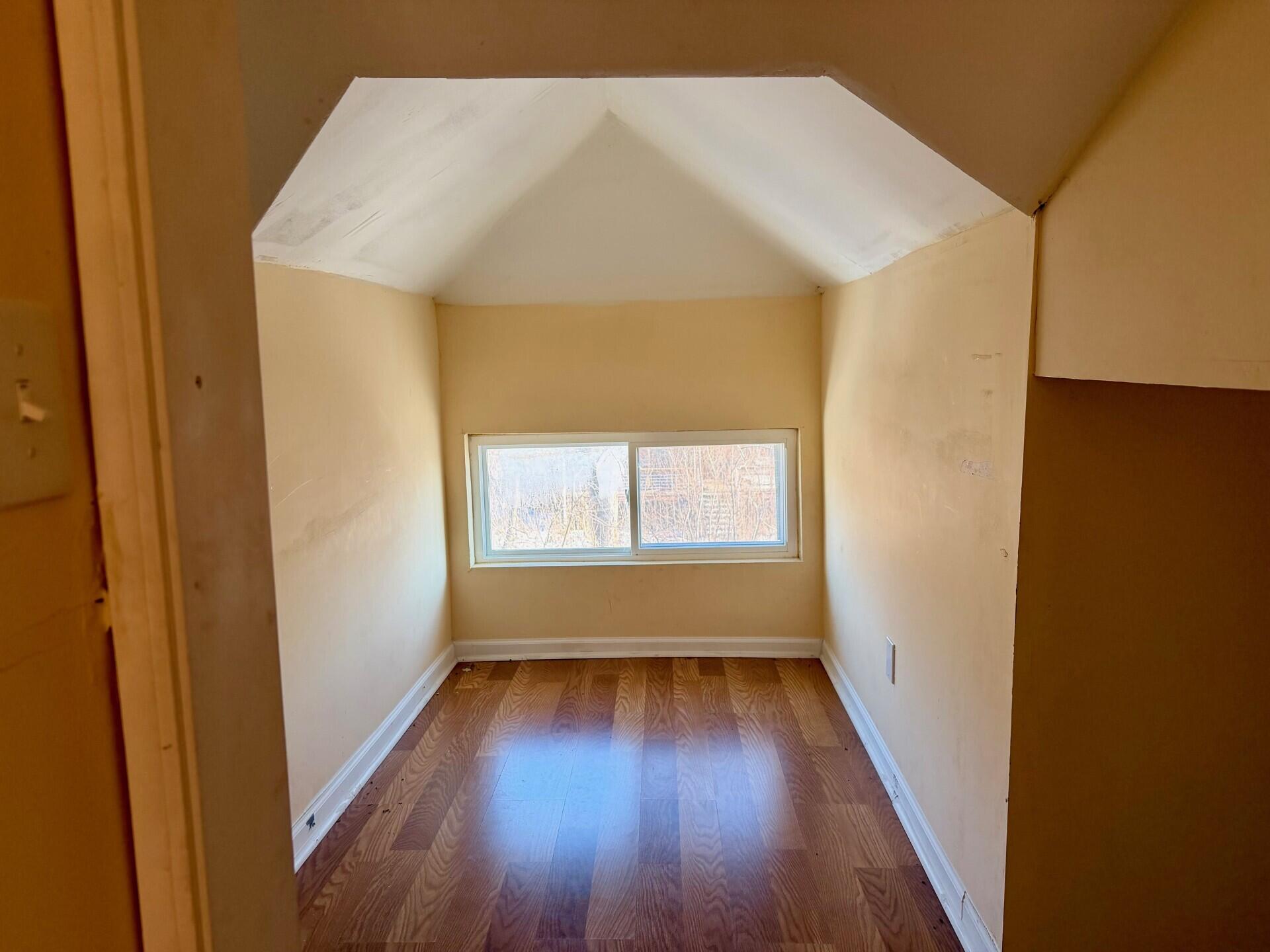4100 Howard Street Hobart, IN 46342 - Photo 5 of 36 an empty room with wooden floor and windows