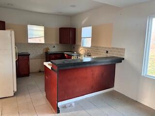 4100 Howard Street Hobart, IN 46342 - Photo 8 of 36 a kitchen with a sink stove and refrigerator
