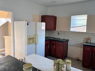 4100 Howard Street Hobart, IN 46342 - Photo 9 of 36 a bathroom with a granite countertop sink and a refrigerator