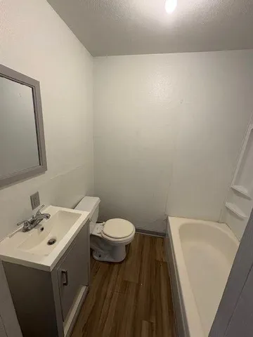 a bathroom with a sink a toilet and mirror