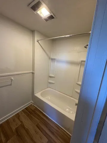 a bathroom with a tub and shower