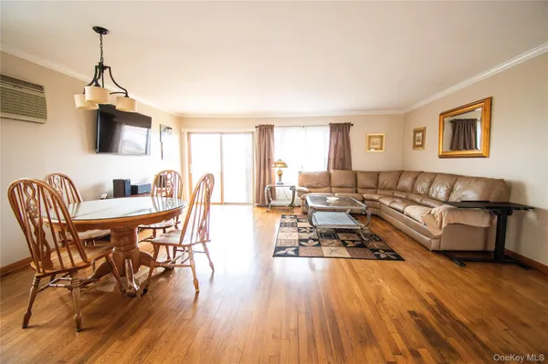 a living room with furniture dining table and a flat screen tv