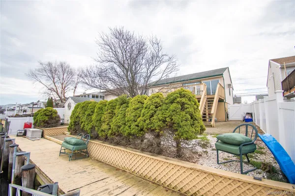 a backyard of a house with outdoor seating