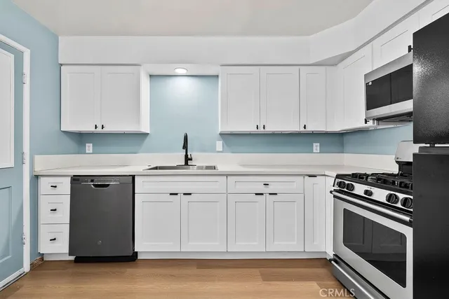 a kitchen with a refrigerator stove and sink