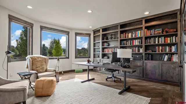 a view of a livingroom with workspace and a window