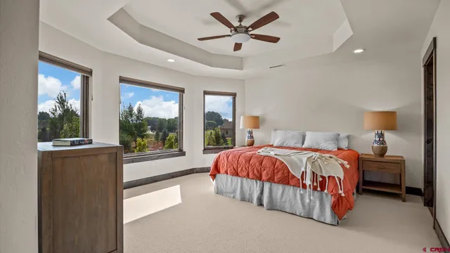 a spacious bedroom with a bed and large window